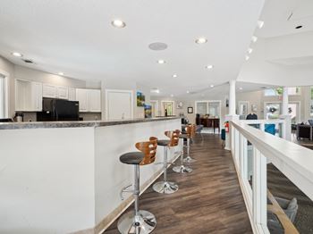 A long white bar with stools and a counter.